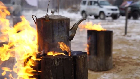 Authentic kettle basked on a Finnish candle bonfire Stock Footage 122200971