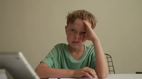 Authentic Kid doing online homework with friends at home, Child using tablet for Stock Footage 194989768