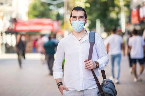 An authentic looking Turkish young man is walking in a street with his protec Foto stock
