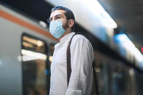 Authentic looking Turkish young man is waiting subway metro with new normal c Foto stock