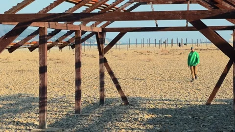 Authentic Man Walking Toward Camera Inside Abandoned Wooden Structure On Pe.. 스톡 동영상 330857466