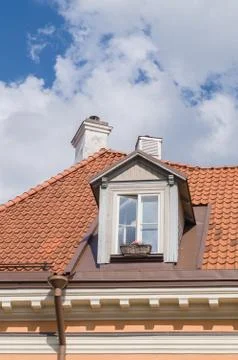 Authentic mansard window in a old style tiled roof Stock Photos