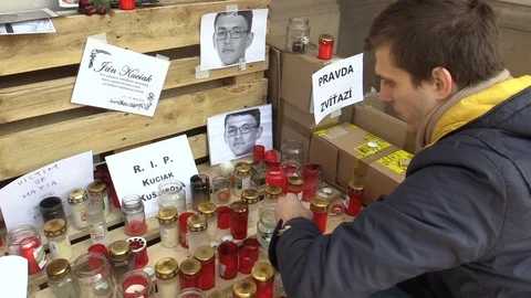 Authentic memorial place with candles and photos of murdered journalist Kuciak Stock Footage 87082200