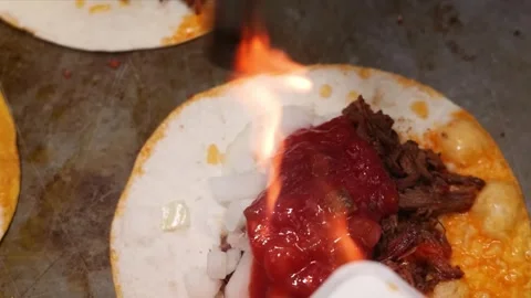 Authentic Mexican Birria Tacos Being Prepared on a Hot Griddle Stock Footage 331635959