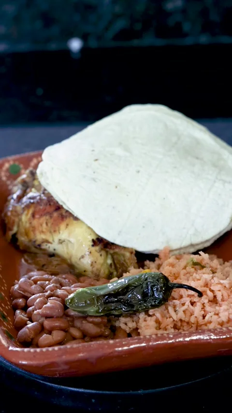Authentic mexican roasted chicken served with rice, beans, a chili pepper, .. Stock Footage 339304617
