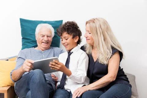 Authentic moment when boy with her grandmother and his grandfather play with  Stock Photos