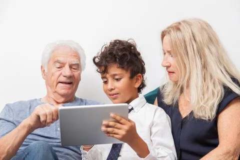 Authentic moment when boy with her grandmother and his grandfather play with  Stock Photos