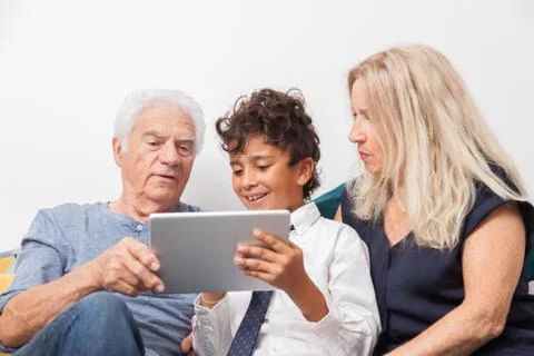 Authentic moment when boy with her grandmother and his grandfather play with  Stock Photos