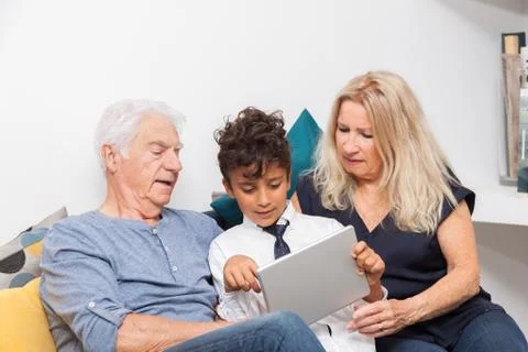 Authentic moment when boy with her grandmother and his grandfather play with  Stock Photos