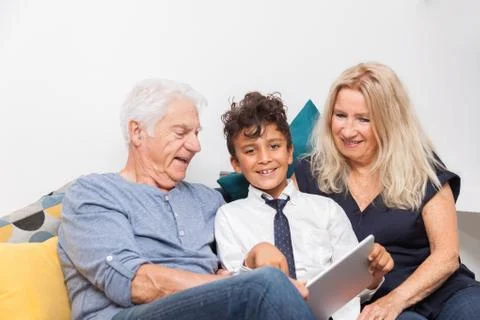 Authentic moment when boy with her grandmother and his grandfather play with  Stock Photos