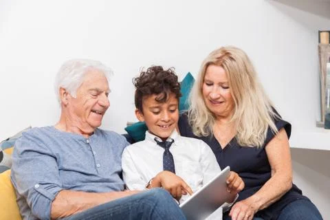 Authentic moment when boy with her grandmother and his grandfather play with  Stock Photos