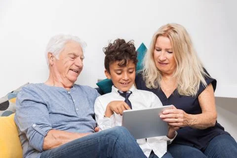 Authentic moment when boy with her grandmother and his grandfather play with  Stock Photos