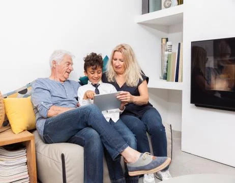 Authentic moment when boy with her grandmother and his grandfather play with  Stock Photos