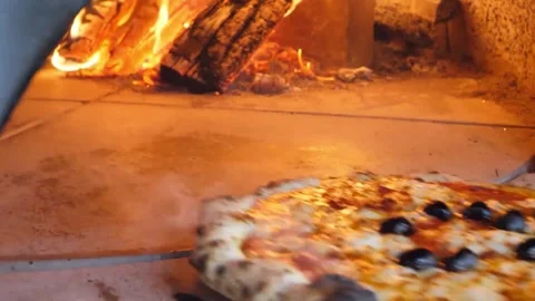 Authentic Neapolitan Pizza Baking in Traditional Wood-Fired Brick Oven Stock Footage 337676648