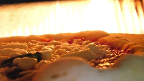 Authentic Neapolitan Pizza Baking in Traditional Wood-Fired Oven with Bright Fla Stock Footage 337676757