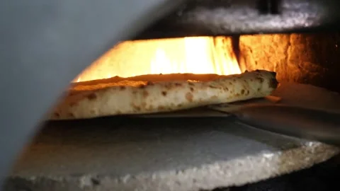 Authentic Neapolitan Pizza Baking in Traditional Wood-Fired Brick Oven Stock Footage 337676895