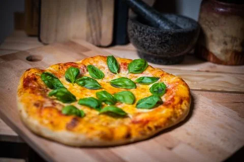 Authentic Neapolitan Pizza with Fresh Basil on Wooden Board Stock Photos
