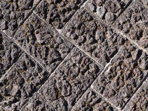 Authentic old and rough textured paved brick wall. Stock-Fotos