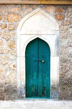 Authentic old door in Arabic style in a stone wall, in minimal style, bright  Stock Photos