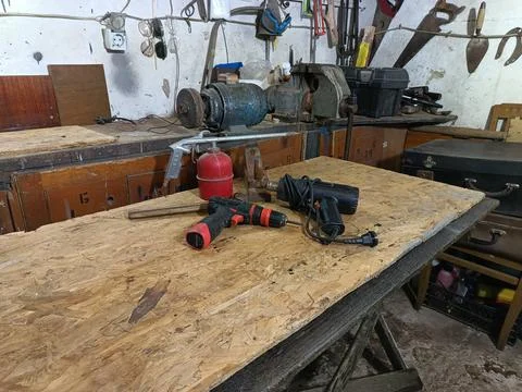 Authentic old workshop interior with tools and workbench Stock Photos