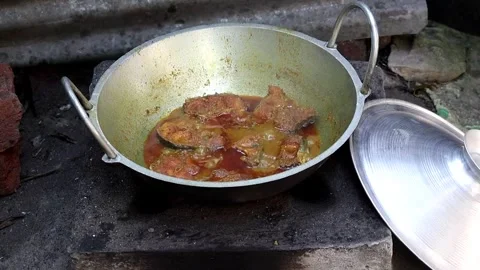 Authentic Pangas Catfish curry simmering in cast iron karahi on a clay chula. Stock Footage 320588074