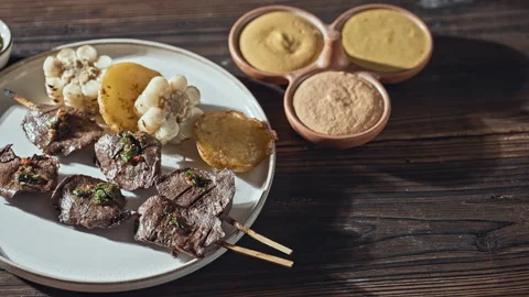 Authentic Peruvian Anticuchos with Corn, Potatoes, and Dipping Sauces Stock Footage 338340792