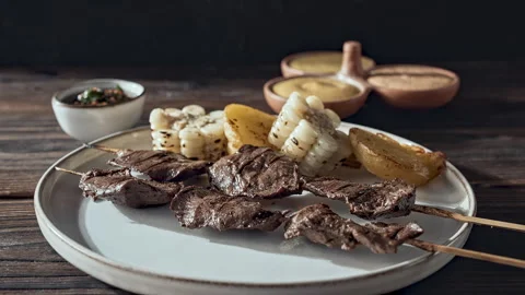 Authentic Peruvian Anticuchos with Corn, Potatoes, and Dipping Sauces Vídeo Stock 338340829