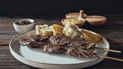 Authentic Peruvian Anticuchos Grilled Beef Heart Skewers with Corn and Potatoes Video stock 339077865