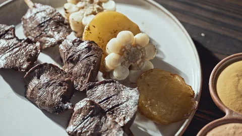 Authentic Peruvian Anticuchos Grilled Beef Heart Skewers with Corn and Potatoes Video stock 341437219