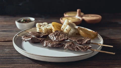 Authentic Peruvian Anticuchos Grilled Beef Heart Skewers with Corn and Potatoes Vídeo Stock 344980913