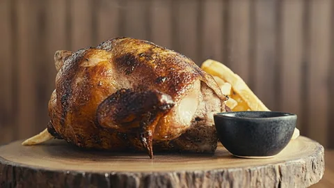 Authentic Peruvian Rotisserie Chicken Pollo a la Brasa with Crispy Fries Stock Footage 338342140