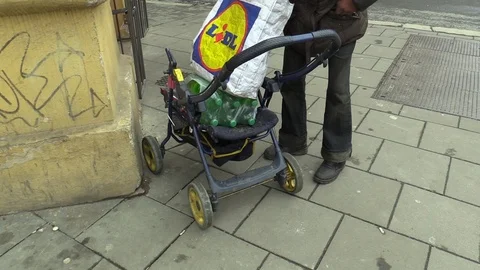Authentic poor homeless hand pulls out a box with cigarette lighters and smokes Stock Footage 89536570