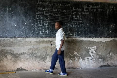 Authentic poor shool classroom with good boys studying Fotos Stock