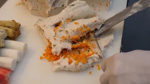 Authentic Preparation of Korean Fish Cake (Eomuk) with Fresh Grated Carrots Stock Footage 337373187