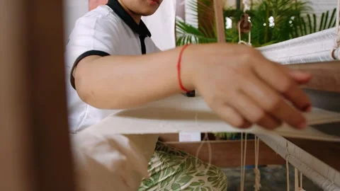 Authentic process of weaving silk by hand in cambodia. Side view of a female Stock Footage 322772751