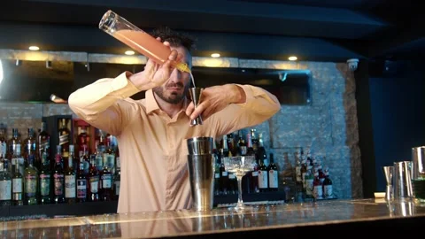 Authentic professional caucasian bartender creating a cocktail drink. Video stock 239101306