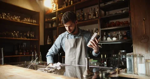 Authentic professional caucasian bartender flaring his shaker before making a Video stock 133254977