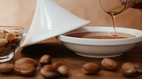 Authentic, pure, organic Argan oil is poured into plate. Stock Footage