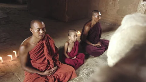 Authentic real monks In Bagan Mayanmar / Burma doing meditation in ancient templ Видео 199476398