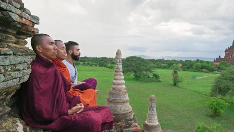 Authentic real monks In Bagan Mayanmar / Burma doing meditation on roof of  anci Stock Footage 201096849