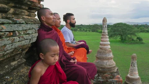 Authentic real monks In Bagan Mayanmar / Burma doing meditation on roof of  anci Stock Footage 201097101