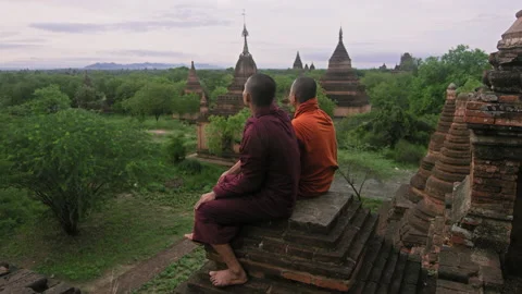 Authentic real monks, looking at view of  Bagan Mayanmar / Burma looking back an Stock Footage 201094263