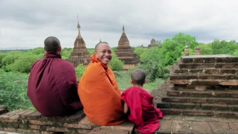 Authentic real monks, over looking view of  Bagan Mayanmar / Burma looking back Stock Footage 201094200