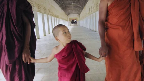 Authentic real monks walking in ancient passage way of temple hand in hand in Ba Stock Footage 201095441