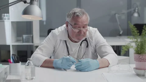 An authentic, reliable doctor examines the lists of new cases of coronavirus Stock Footage 152344684