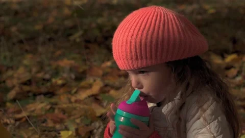 Authentic sad serious little cute caucasian preschool baby girl in orange beret Stock Footage 151228853