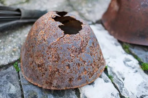 Authentic Second World War helmet with bullet hole. The old rusty soldier's h Stock Photos