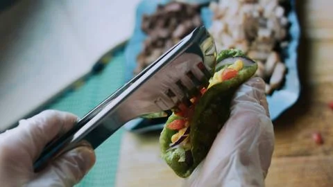 Authentic serving composition: adding creamy pickle sauce to a lettuce wrap Stock Photos