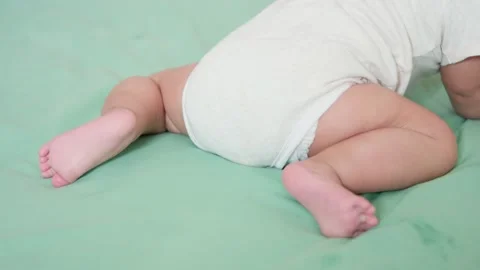Authentic shot of back view small leg and foot Cute baby newborn crawling or  Video stock 218291117