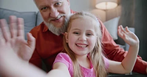 Authentic shot of happy smiling father and daughter are making a selfie or video Stock Footage 152402467